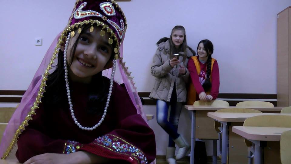 One of his students wearing the Armenian Taraz (traditional custom)