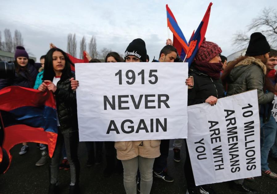 An Armenian protester holds a banner reading ‘1915 never again’ as she takes part in a demonstration near the European Court of Human Rights in Strasbourg in January. (photo credit:REUTERS)